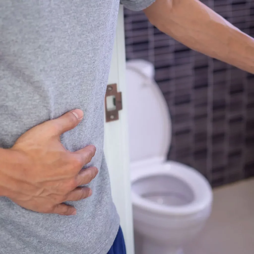 a man with stomach issues entering toilet